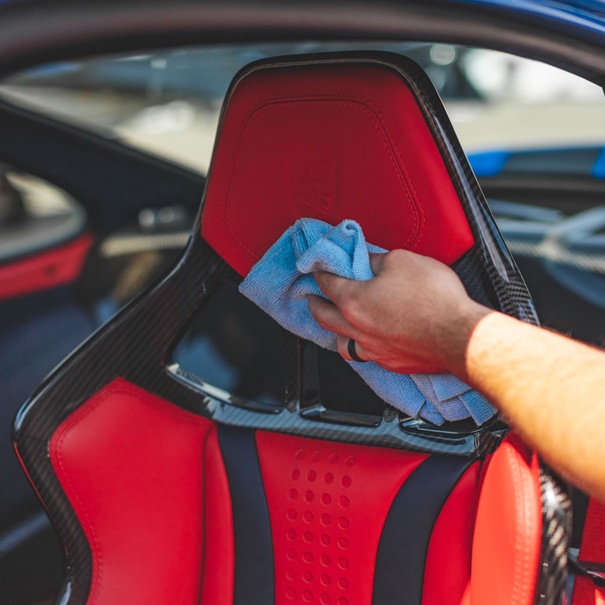 Detailer cleaning leather seats with P&S Xpress Interior Cleaner