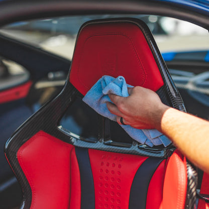 Detailer cleaning leather seats with P&S Xpress Interior Cleaner